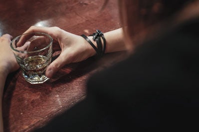 Woman drinking glass of alcohol