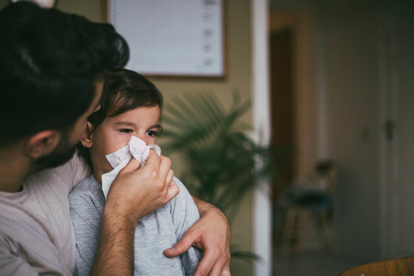 Father blowing his child's nose