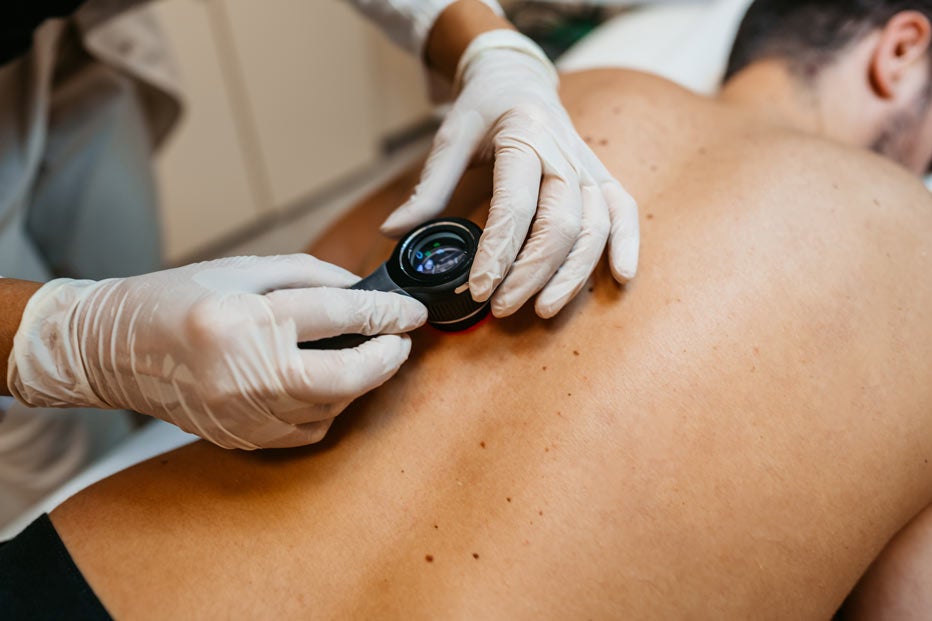 Doctor examining a man's back